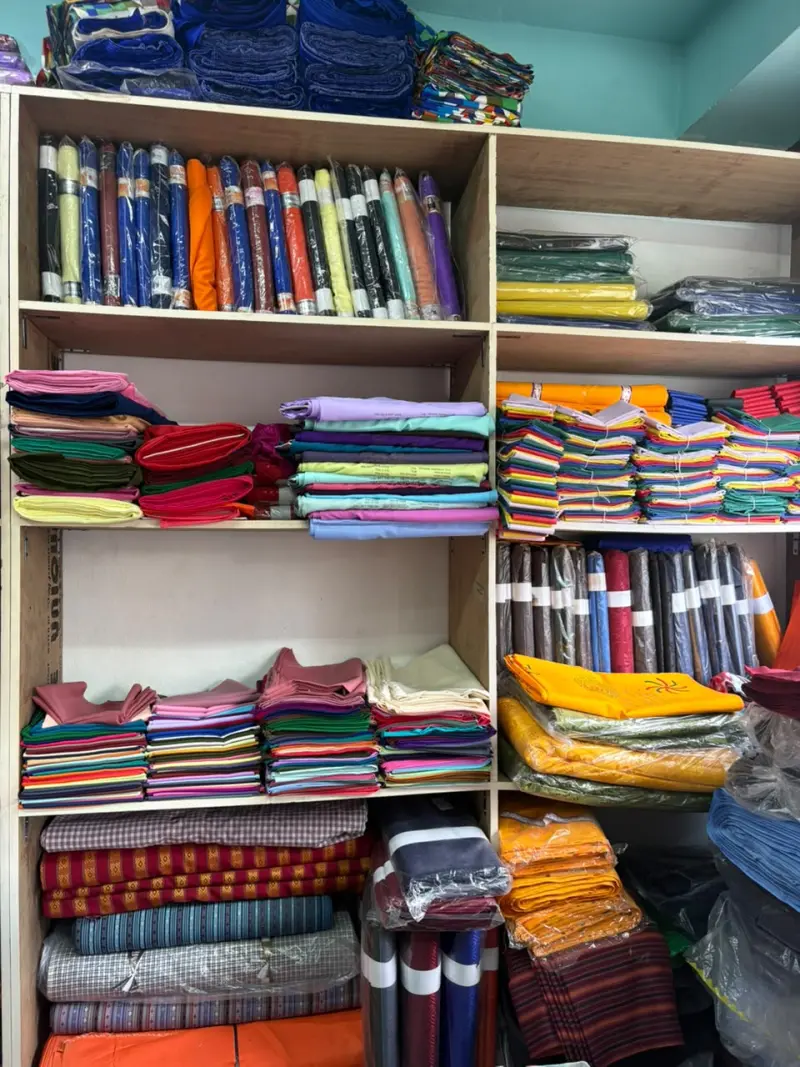 Folded fabric and trims stocked on shop shelving