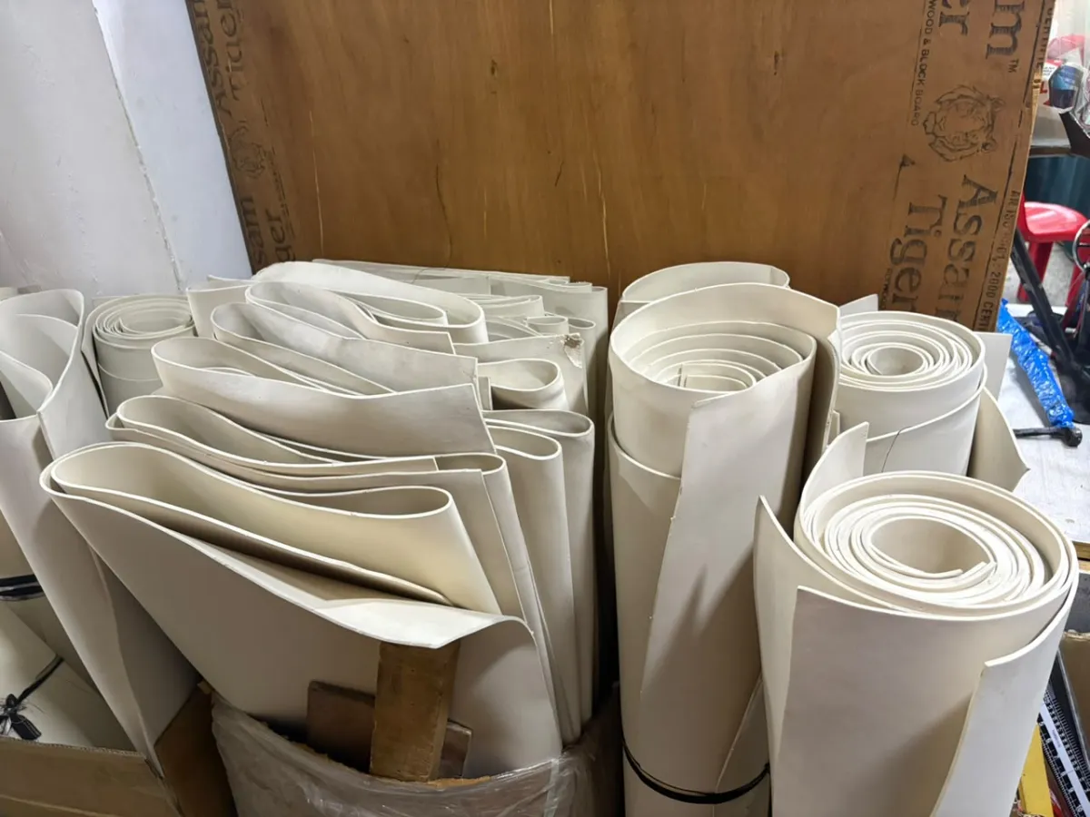 Rolls of interfacing and lining material stacked in the shop